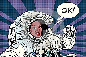 OK gesture woman astronaut in a spacesuit photo