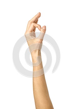 Ok sign. Woman hand gesturing isolated on white