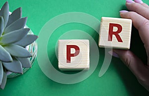 Ok symbol. Concept word Ok on wooden cubes. Businessman hand. Beautiful green background with succulent plant. Business and Ok