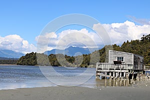 Okarito lagoon and wooden building on stilts, NZ