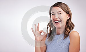 Okay, agreement and portrait of happy woman in studio mockup with positive attitude. Thank you, smile and girl with ok