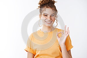 Okay do it. Portrait friendly happy satisfied attractive redhead girl grinning show ok gesture give positive reply