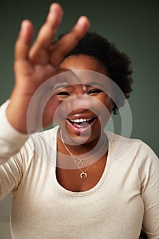 Okay sign, eye and black woman portrait in studio with smile for approval, attitude or happy on green background. Face