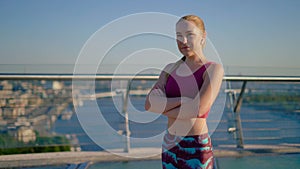 Okay! sporty pretty young girl runner approvingly shows ok gesture. Girl with wireless headphones. 4K