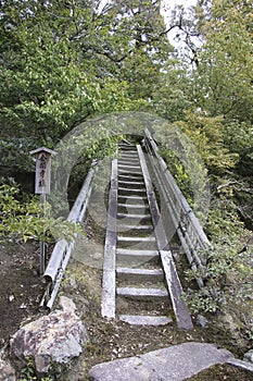 okei-kyo stairs with bamboo fences in the Zen temple Kinkakuji complex and garden in February, Kyoto Japan