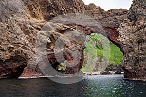 Oki Islands, Japan. Colorful rocks and rock gate with view on the spectacular coast of Unesco Global Geopark, Sea of Japan