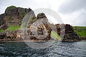 Oki Islands, Japan. Colorful rocks and rock gate with view on the spectacular coast of Unesco Global Geopark, Sea of Japan