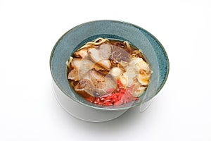 Okinawan style noodle soup with pork isolated on a white background