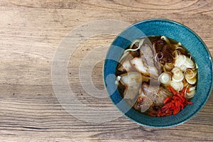 Okinawan style noodle soup with pork on a wooden table