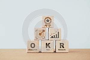 OKR, objective key results, text on wooden cube blocks. Business target and drive business and performance. Focus on goal. Project