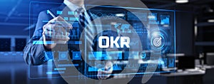 OKR Objectives key results. Businessman pressing button on screen