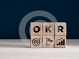 OKR Objectives and Key Results concept on wooden cubes. Business target, growth achievement and performance