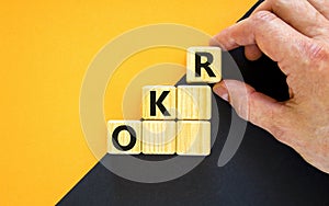 OKR, objectives and key results symbol. Concept words `OKR, objectives and key results` on cubes on a beautiful black background