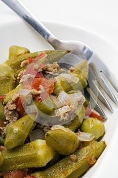 Okra on white plate with fork