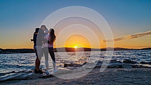 Okrug - Silhouette of loving parents holding small toddler at romantic sunset in Okrug Gornij, Split-Dalmatia, Croatia