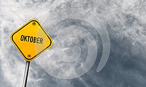 Oktober - yellow sign with cloudy sky