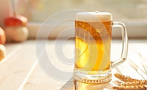 Oktoberfest beer. Glass beer mugs full of golden lager with thick frothy heads conceptual of Oktoberfest. Beer mug. Big glass of