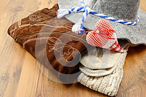 Oktoberfest cloths like lederhosen, felt hat and traditional soc photo