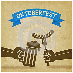 Oktoberfest concept. Hand with beer mug and sausage old background