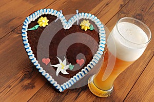 Oktoberfest gingerbread heart cookie with copy space and weissbier glass photo