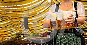 Oktoberfest, Munich. Waiter serve beer, close up. Octoberfest German festival