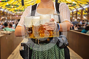 Oktoberfest, Munich. Waiter serve beer, close up. Octoberfest German festival photo