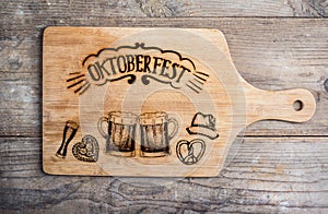 Oktoberfest sign with various hand drawn symbols, cutting board