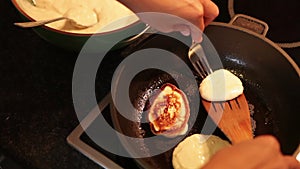 Oladji (little pancakes) roasting on the pan top view