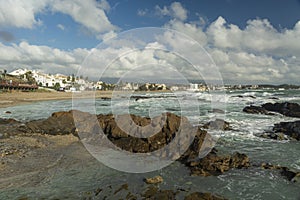 olas rompen sobre las rocas un dÃ­a de verano en el mediterraneo photo