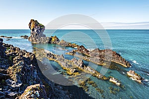 Olcanic lava formations at the coastline of Djupalonssandur Bay, in Icelandic Snaefellsjokull National Park