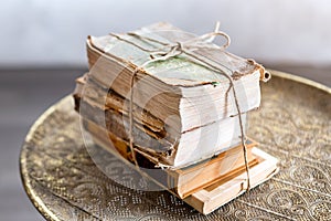 Old 100 years books on antique table closeup. History, knowledge, nostalgia, old age concept. Retro style.