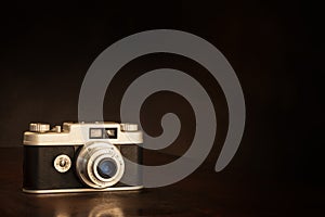 Old 1950s 35mm Camera On Brown Background With Copy Space