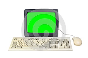 Old 1990s computer with green screen for adding videos and images, retro keyboard and mouse isolated on white background.