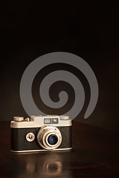 Old 35mm Camera On Brown Background With Copy Space Vertical
