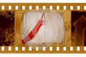 Old 35mm frame photo with vintage book and feather
