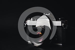 Old 35mm SLR film camera on black background. Flim photography concept
