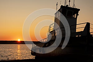 Old or abandon boat or ship on the beach with sunlight of sunrise on the morning