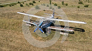 Old abandoned airplane on the field. Top view