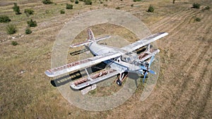 Old abandoned airplane on the field. Top view