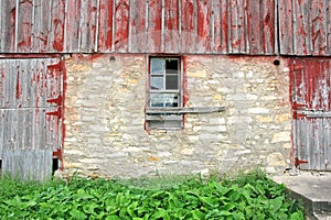 Old Abandoned Barn with Broken Window and Two Wood Doors