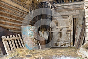 Old abandoned barn with metal barrels