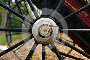 Old abandoned black metal wheel of farm machinery from 19th century