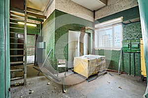 Old abandoned brick building with green walls