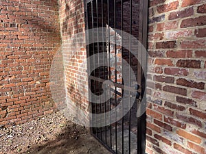 Old abandoned brick building locked metal bar door