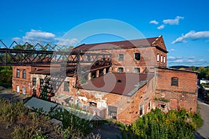 An old abandoned brick factory against a bright sky