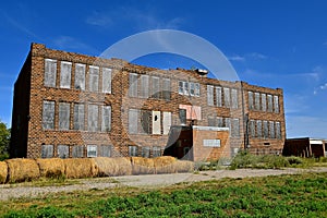 Old abandoned schoolhouse falling into ruins