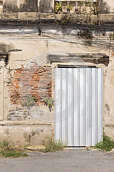 Old Abandoned Building Door Obstructed by Galvanized Sheet photo