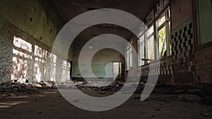 Old abandoned building. General plan of the room. Cinematic plan. The sun shines through the Windows.