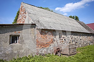 An old abandoned building with roof made of carcinogenic asbestos tiles photo