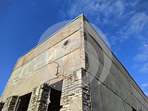 old abandoned building during summer daytime against blue sky.